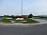 We leave the hilly vineyards behind and reach a nicely groomed roundabout on the flat area with the Slovene border right behind it.